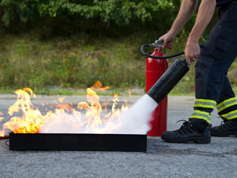 Instructor,Showing,How,To,Use,A,Fire,Extinguisher,On,A